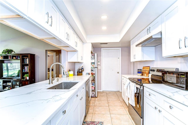 4110 Summerdale Dr, Tampa, FL 33624 - kitchen featuring white cabinetry, light tile patterned floors, stainless steel appliances, under cabinet range hood, and a sink