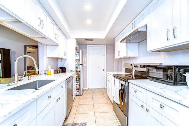 4110 Summerdale Dr, Tampa, FL 33624 - kitchen with white cabinets, stainless steel appliances, a raised ceiling, under cabinet range hood, and a sink