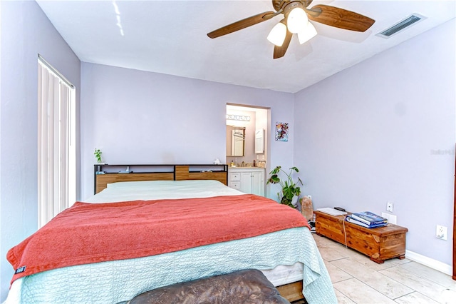 4110 Summerdale Dr, Tampa, FL 33624 - bedroom with light tile patterned flooring, ensuite bathroom, visible vents, baseboards, and a ceiling fan