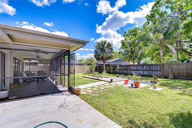 4110 Summerdale Dr, Tampa, FL 33624 - view of yard with a ceiling fan, a fenced backyard, and a patio area