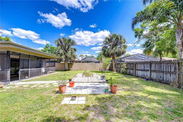 4110 Summerdale Dr, Tampa, FL 33624 - view of yard featuring a fenced backyard, a sunroom, and a patio area