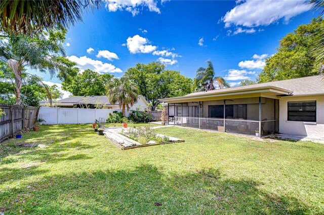 4110 Summerdale Dr, Tampa, FL 33624 - view of yard with a garden, a sunroom, and a fenced backyard