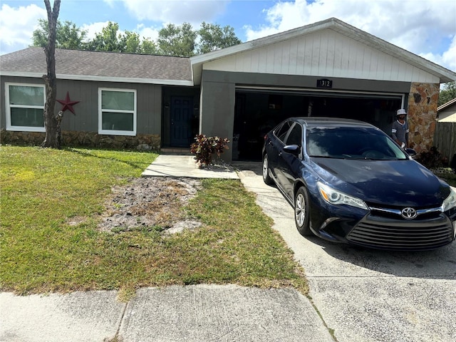 1312 Foxboro Dr, Brandon, FL 33511 - single story home featuring stone siding, driveway, an attached garage, and a front yard