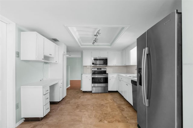 kitchen featuring a tray ceiling, light countertops, white cabinetry, stainless steel appliances, and visible vents
