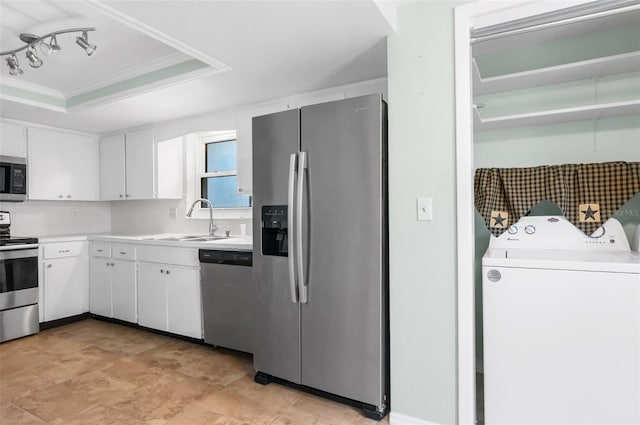 kitchen featuring white cabinetry, a raised ceiling, a sink, and stainless steel appliances