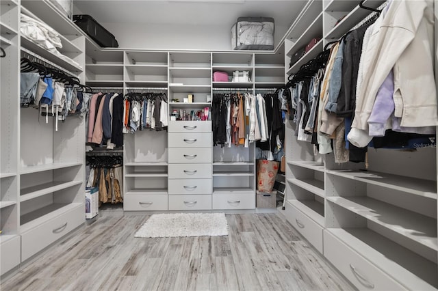 walk in closet with wood finished floors