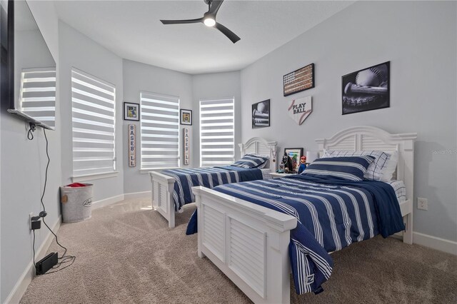 bedroom with light carpet, baseboards, and ceiling fan