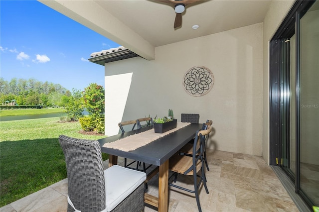 view of patio / terrace featuring outdoor dining area and a ceiling fan