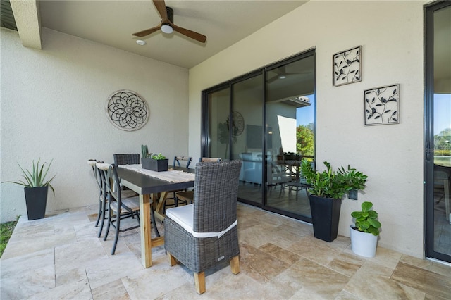 view of patio / terrace with outdoor dining area and a ceiling fan