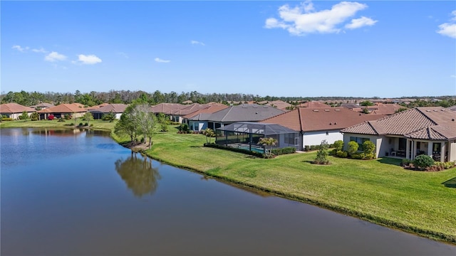 drone / aerial view with a residential view and a water view