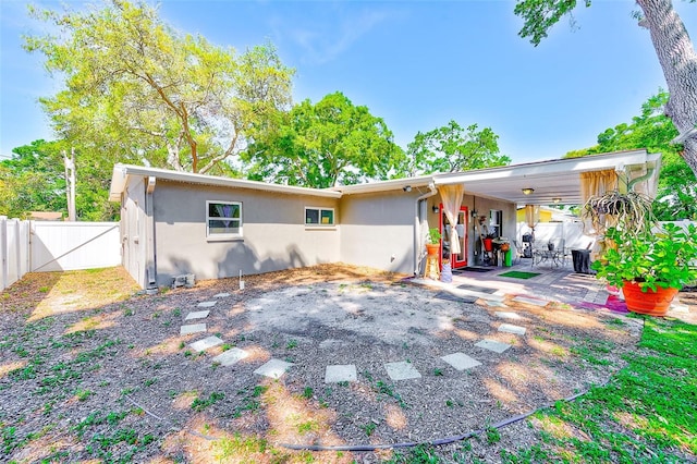 700 16th St NW, Largo, FL 33770 - rear view of property with a fenced backyard, a patio, and stucco siding