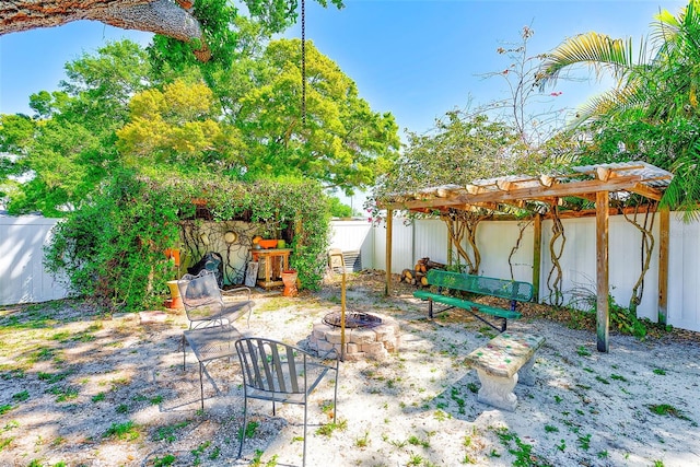 700 16th St NW, Largo, FL 33770 - view of patio with a pergola, a fenced backyard, and a fire pit