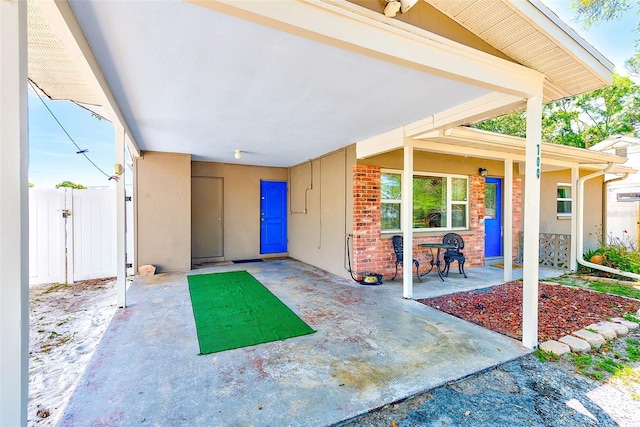 700 16th St NW, Largo, FL 33770 - view of patio featuring fence and a porch