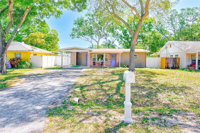 700 16th St NW, Largo, FL 33770 - ranch-style home featuring a gate, driveway, and fence