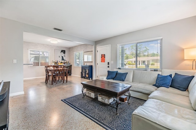 2808 W Lake Ave, Tampa, FL 33607 - living room with speckled floor, baseboards, and visible vents