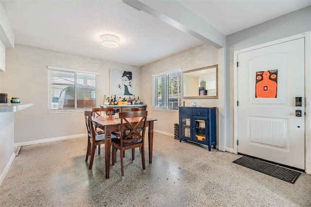 2808 W Lake Ave, Tampa, FL 33607 - dining area with speckled floor, baseboards, and a wealth of natural light