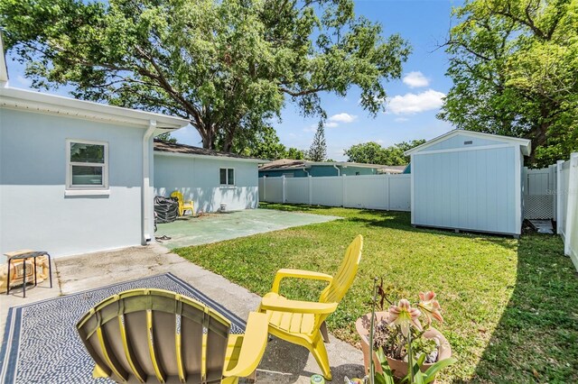 2808 W Lake Ave, Tampa, FL 33607 - view of yard featuring a patio, a storage unit, a fenced backyard, and an outdoor structure