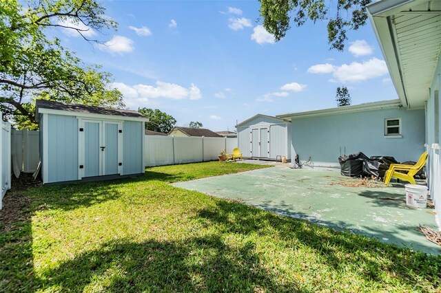 2808 W Lake Ave, Tampa, FL 33607 - view of yard with a storage shed, a patio, an outbuilding, and a fenced backyard