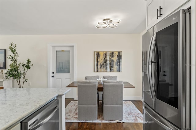 601 Boca Ciega Isle Dr, St Pete Beach, FL 33706 - dining room featuring dark wood-style floors and baseboards