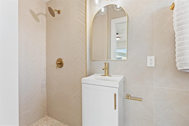 601 Boca Ciega Isle Dr, St Pete Beach, FL 33706 - bathroom with a tile shower, ceiling fan, and vanity