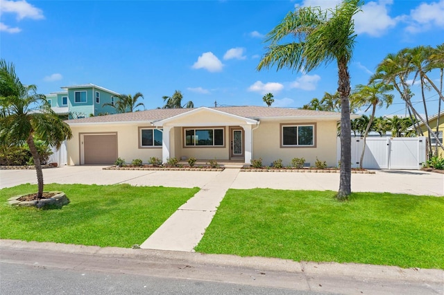 601 Boca Ciega Isle Dr, St Pete Beach, FL 33706 - single story home featuring stucco siding, a gate, a front lawn, and concrete driveway