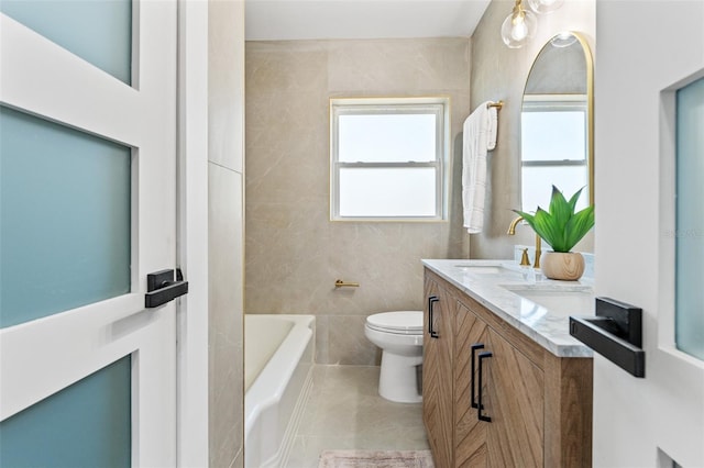 601 Boca Ciega Isle Dr, St Pete Beach, FL 33706 - full bath featuring tile walls, toilet, a sink, a bath, and double vanity