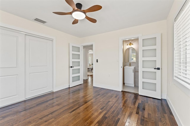601 Boca Ciega Isle Dr, St Pete Beach, FL 33706 - bedroom featuring a closet, baseboards, visible vents, and dark wood finished floors