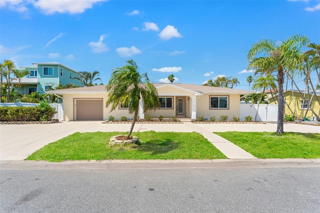601 Boca Ciega Isle Dr, St Pete Beach, FL 33706 - single story home featuring concrete driveway, stucco siding, fence, an attached garage, and a gate
