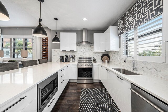 2511 N Grady Ave Unit 82, Tampa, FL 33607 - kitchen with wall chimney exhaust hood, appliances with stainless steel finishes, a sink, light countertops, and recessed lighting