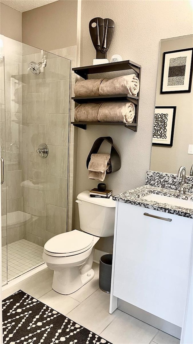 2511 N Grady Ave Unit 82, Tampa, FL 33607 - bathroom featuring toilet, vanity, a stall shower, and tile patterned floors