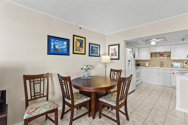 dining space with a textured ceiling, ceiling fan, and ornamental molding