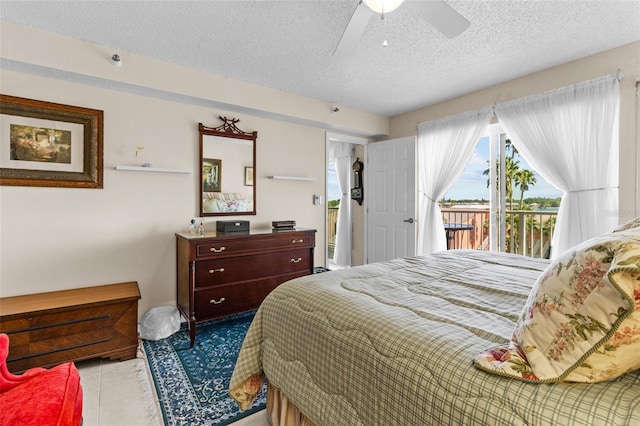 bedroom featuring a textured ceiling, ceiling fan, tile patterned flooring, and access to outside