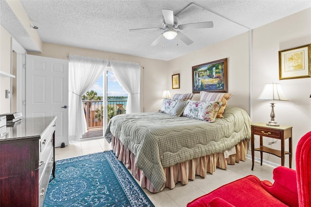 bedroom with a ceiling fan, light tile patterned floors, access to exterior, and a textured ceiling