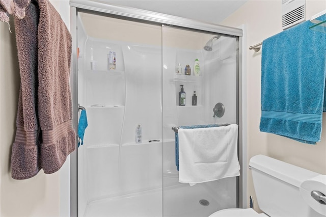 bathroom featuring a shower stall, visible vents, and toilet