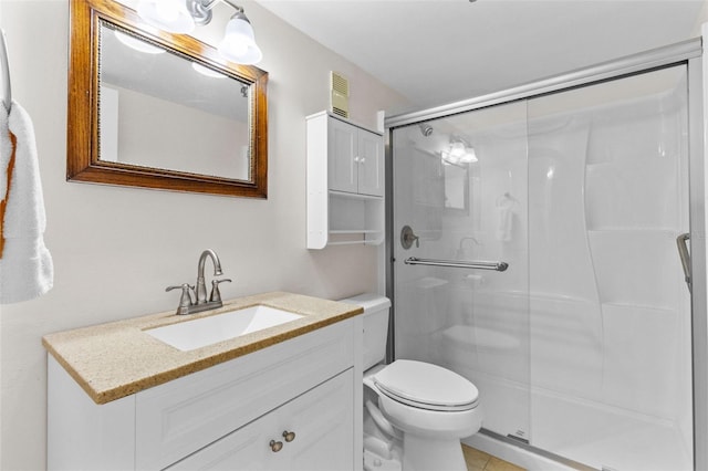 bathroom with toilet, a stall shower, tile patterned floors, and vanity