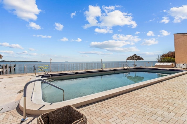view of swimming pool featuring a water view