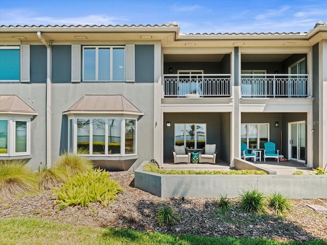 2087 Edgewater Dr Unit C, Clearwater, FL 33755 - back of house featuring a balcony, stucco siding, outdoor lounge area, and a patio area