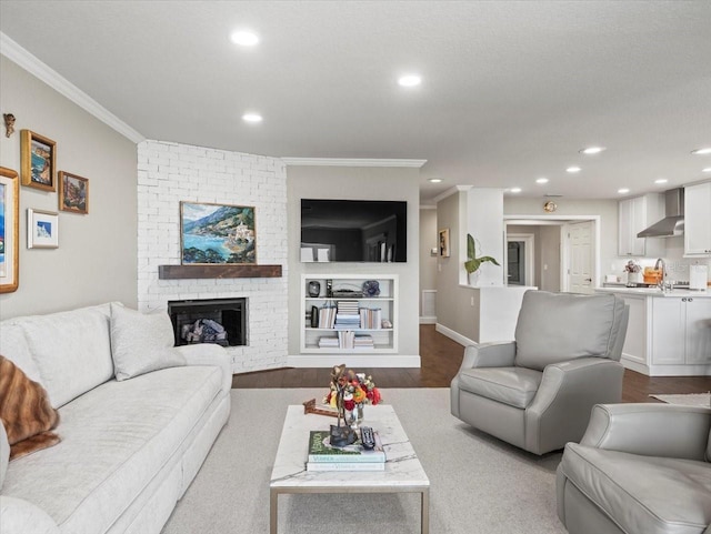 2087 Edgewater Dr Unit C, Clearwater, FL 33755 - living room featuring crown molding, recessed lighting, a brick fireplace, and dark wood-type flooring