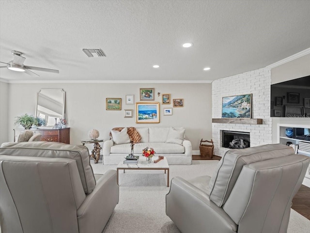 2087 Edgewater Dr Unit C, Clearwater, FL 33755 - living room featuring crown molding, a textured ceiling, a ceiling fan, recessed lighting, and a brick fireplace
