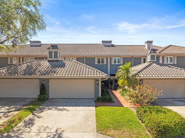 2087 Edgewater Dr Unit C, Clearwater, FL 33755 - view of front facade featuring a tile roof, stucco siding, and concrete driveway