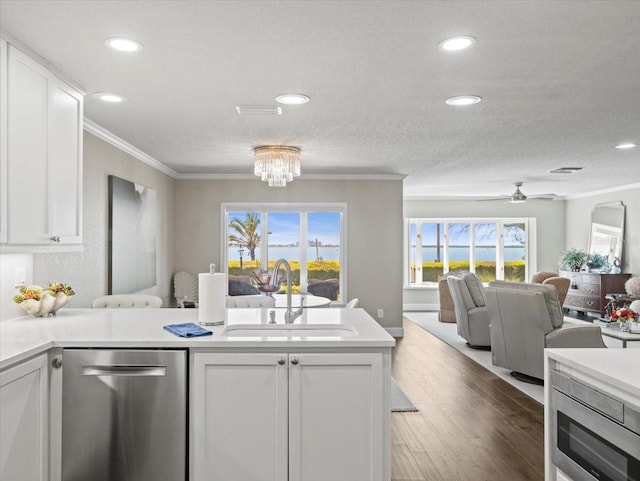 2087 Edgewater Dr Unit C, Clearwater, FL 33755 - kitchen with stainless steel dishwasher, open floor plan, crown molding, recessed lighting, and light countertops