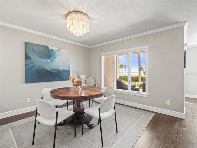 2087 Edgewater Dr Unit C, Clearwater, FL 33755 - dining room featuring wood finished floors, ornamental molding, a chandelier, and a textured ceiling