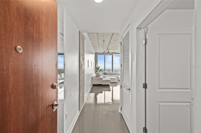 777 N Ashley Dr Unit 2807, Tampa, FL 33602 - hall with tile patterned floors, expansive windows, and an inviting chandelier
