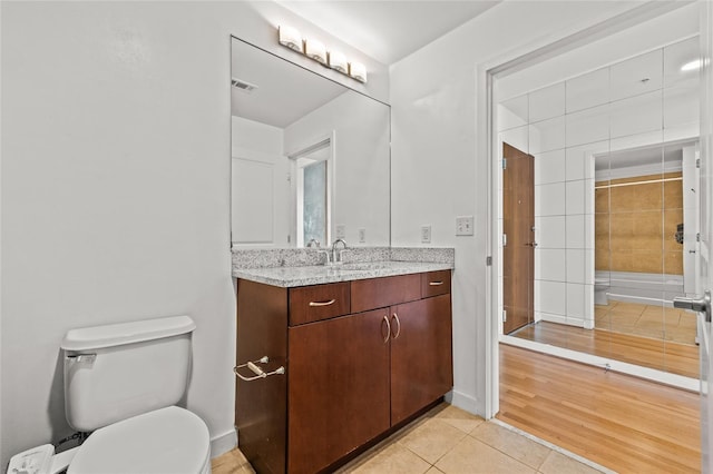 777 N Ashley Dr Unit 2807, Tampa, FL 33602 - bathroom with tile patterned floors, toilet, vanity, baseboards, and visible vents