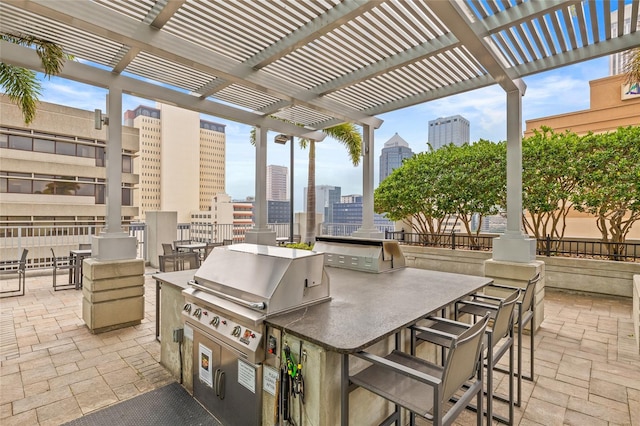 777 N Ashley Dr Unit 2807, Tampa, FL 33602 - view of patio / terrace with a pergola, exterior kitchen, area for grilling, and a city view