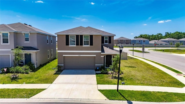 view of front facade with a garage, stucco siding, a front yard, concrete driveway, and a residential view