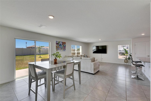 dining room with visible vents, baseboards, recessed lighting, and plenty of natural light