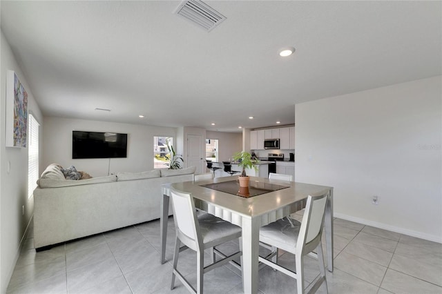 dining space featuring light tile patterned flooring, baseboards, visible vents, and recessed lighting