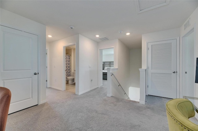 interior space featuring carpet flooring, baseboards, visible vents, and recessed lighting