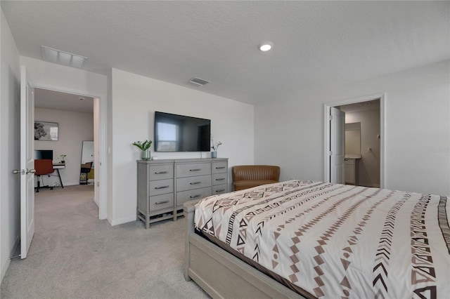 bedroom with light carpet, visible vents, a textured ceiling, and baseboards